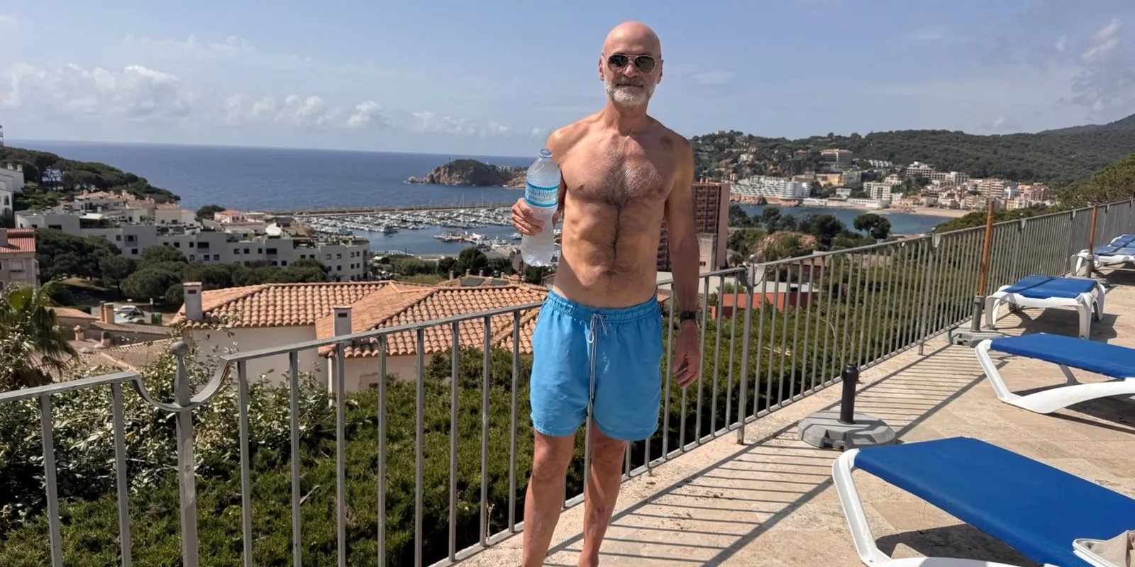 Neil Stanley on the final day of a five-day water-only fast, on a coastal terrace overlooking a Mediterranean harbour in Spain, 2026